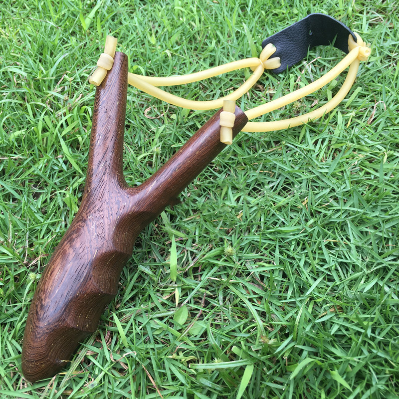 

Solid wood slingshot fits the unique design of the hand. Comfortable finger concave with anti-slip effect adult outdoor sports tools