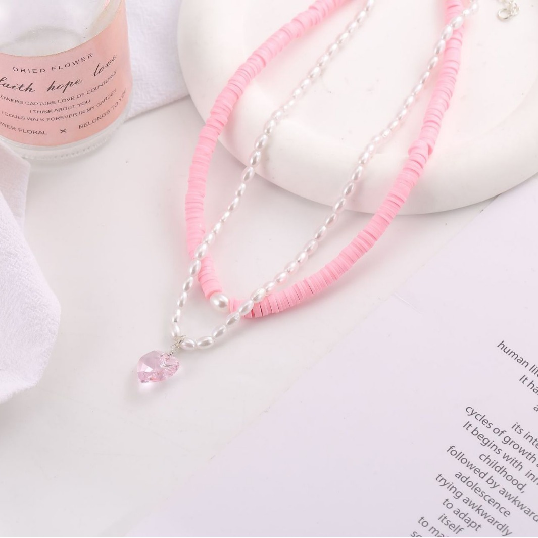 New spring summer collection: egg-shaped pearl necklace with pink crystal heart pendant, soft clay clavicle chain, and a versatile two-piece set