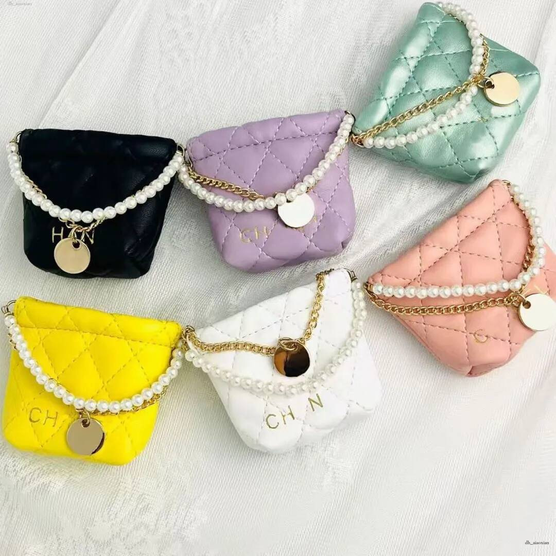 2026 designer's new mini garbage trendy diamond grid chain headphone pearl bucket car keychain bag pendant