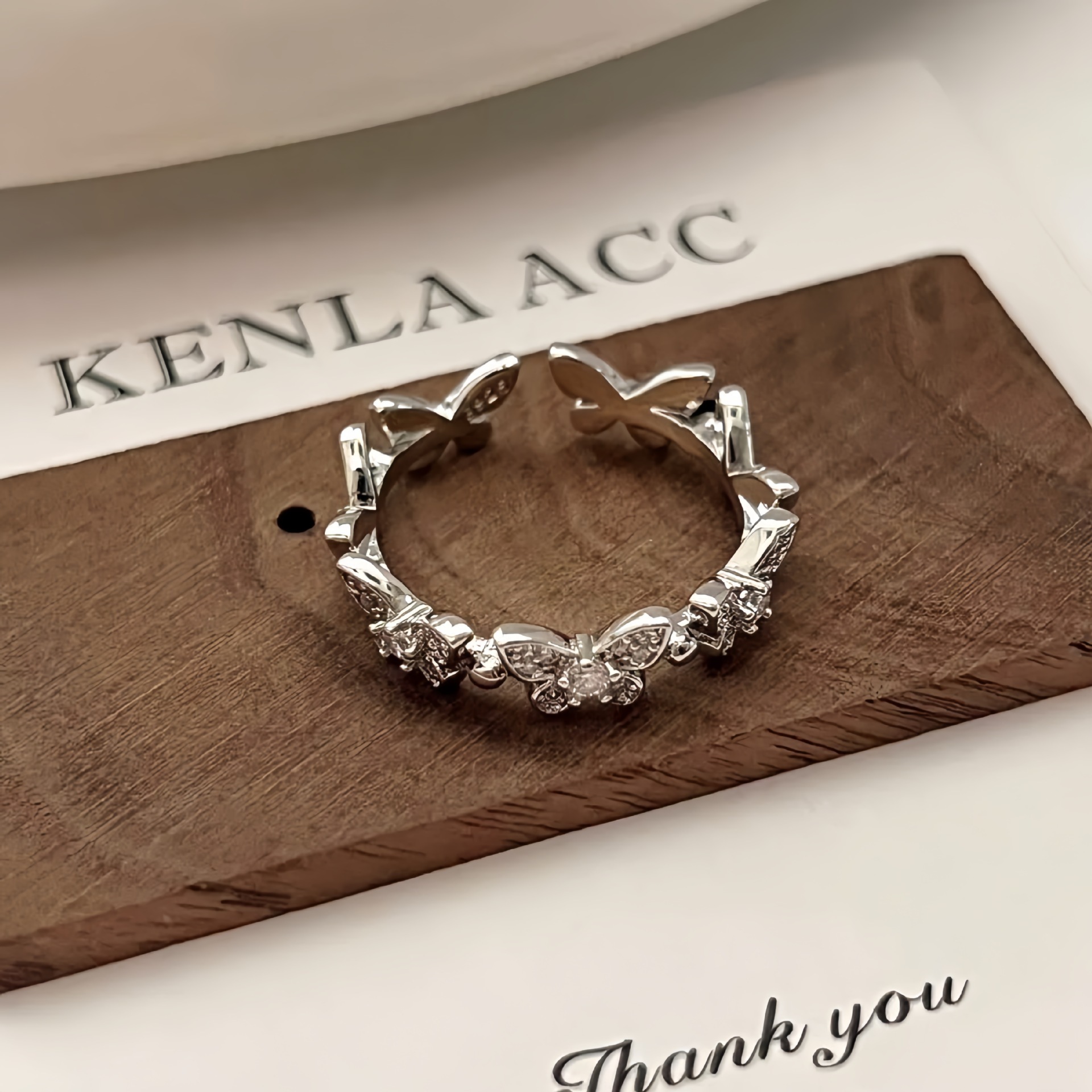 Sparkling diamond butterfly ring, niche high-end luxury piece women, featuring an open design, a cool understated style, and intricate craftsmanship