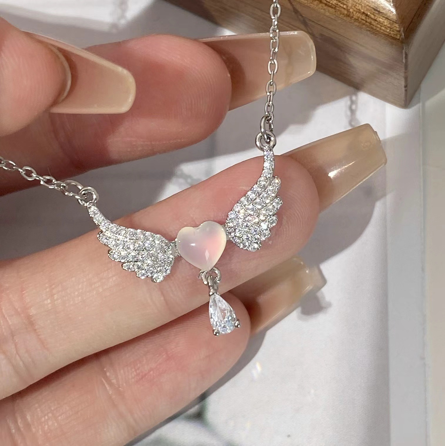 New pink peach heart wing necklace for women, featuring delicate unique design with touch of luxury, creating a sweet and elegant clavicle chain. (P