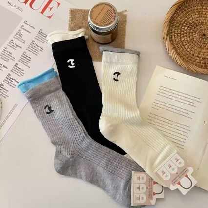 Handmade double-layered socks with a premium, understated luxury feel, available basic black white colors, in mid-calf and short lengths, trendy sty