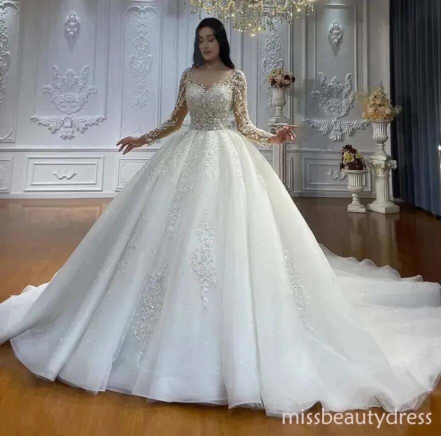 2025 Hot Sexy Ball Gown Wedding Dresses Scoop Neck Illusion Long Sleeves Sequined Lace Appliques Crystal Beaded Plus Size Bridal Gowns Chapel Train