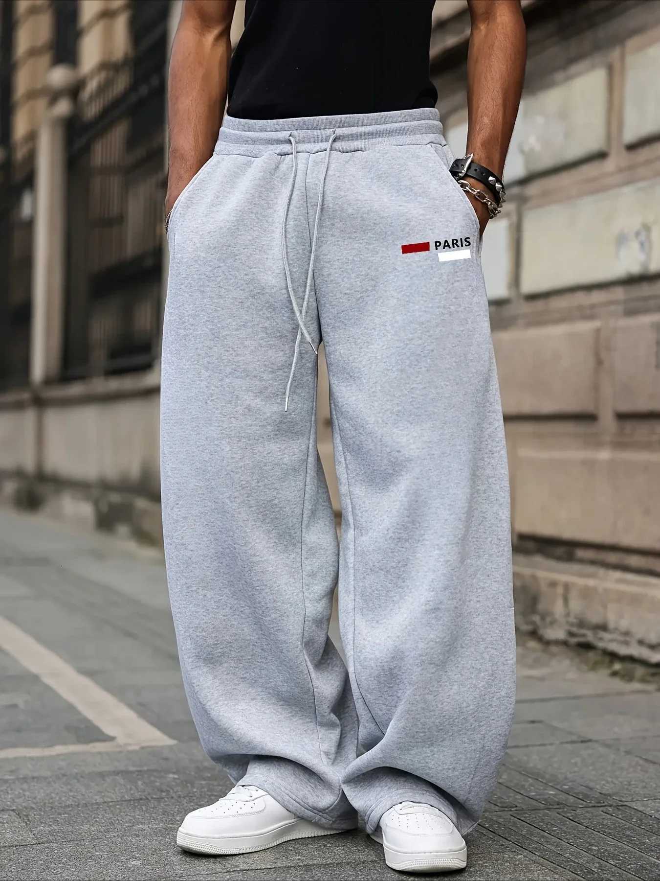 Men's Pants Unisex solid color loose sports pants with drawstring elastic waist. Fall and winter casual wide-leg pants. Parisian text print. H2