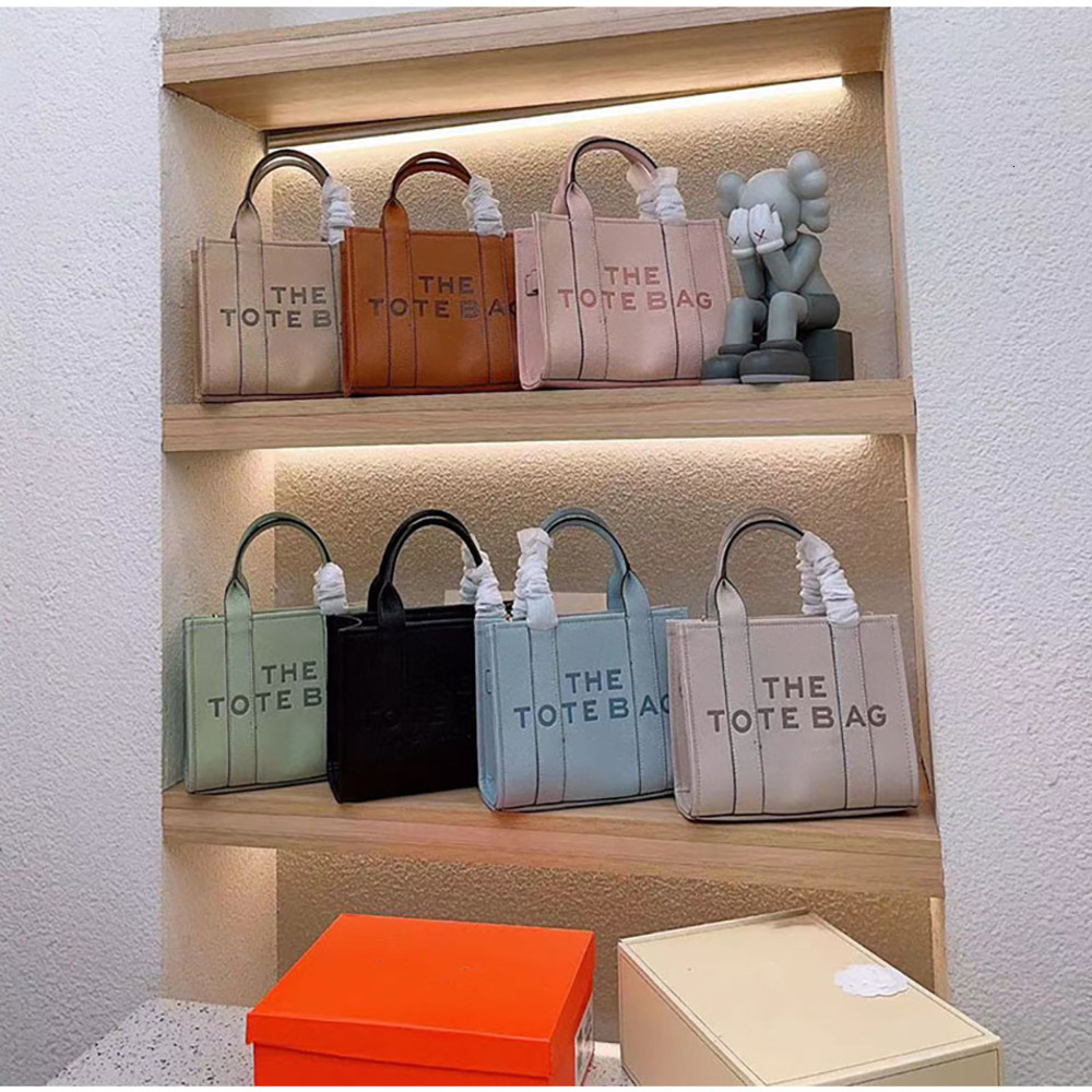The tote bag Designer bags Women men High quality leather Fashion high-capacity Shoulder Letter printing Shopping Handbag 2 sizes multiple colors 34