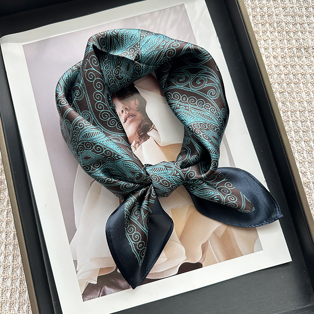 A genuine silk scarf in the green totem style, suitable for women to wear. It offers a fashionable and elegant neck support function. It is a small-