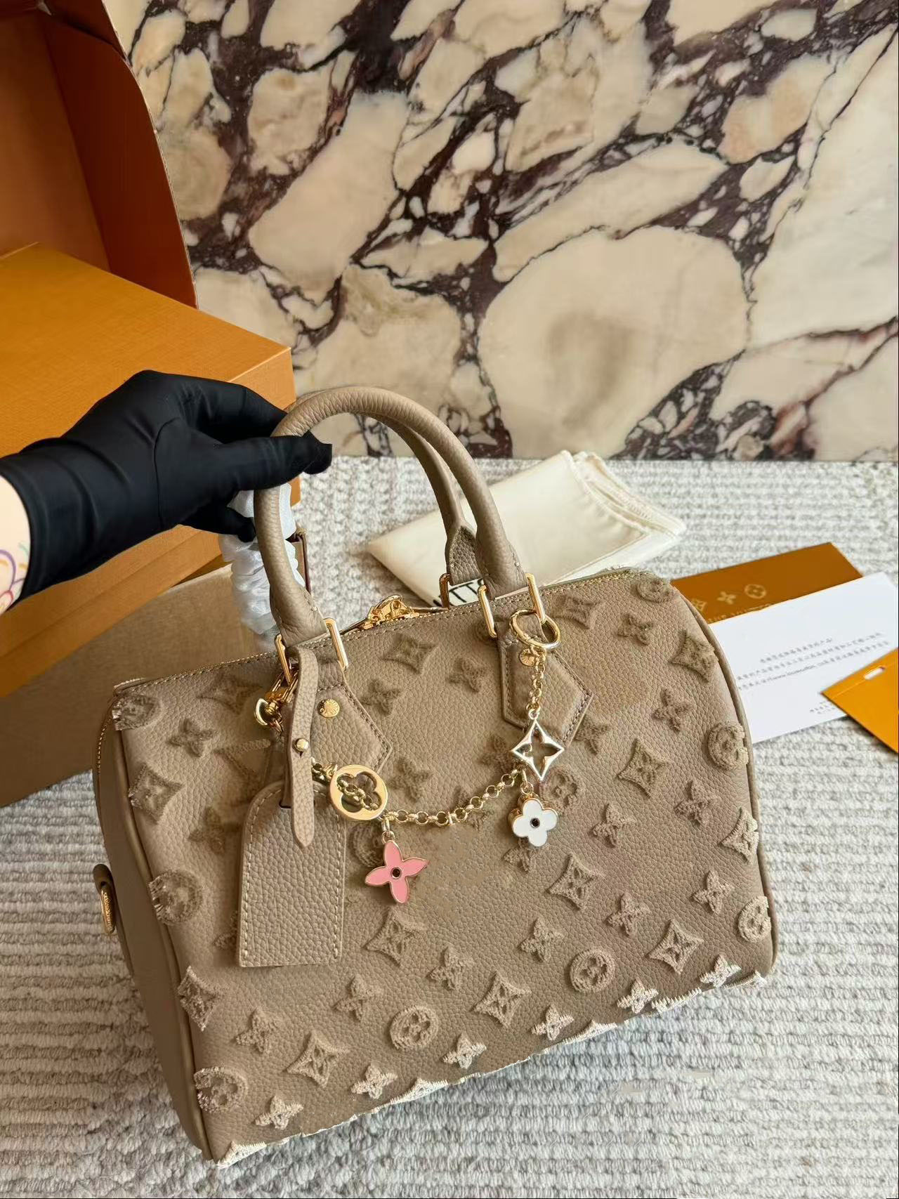 Designer bag Monogram canvas and cowhide trimmed with vintage flowers in 32 vibrant colors, showcasing white tri color and black tri color, launchin