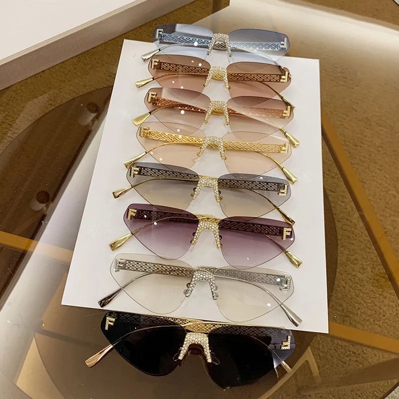 2026 New Designer Frameless Cat Eye Sunglasses Luxury Fashion Hollow Metal Outdoor Glasses Fashion Brand Diamond Inlaid Letters Free ShippingAAAA