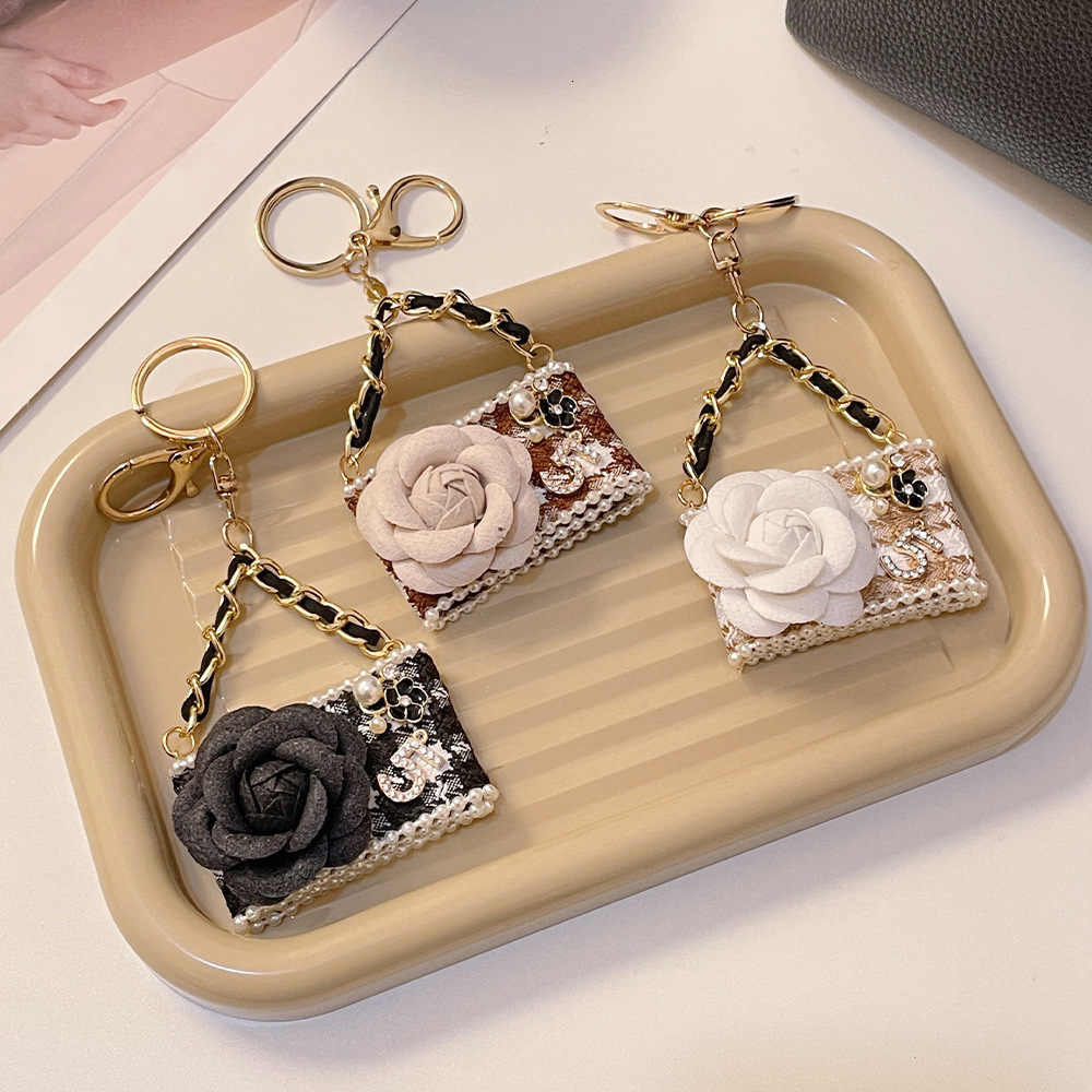 Keychains Lanyards designer keychain korean version fashionable camellia model keychain creative handmade car womens bag pendant accessory gift bag