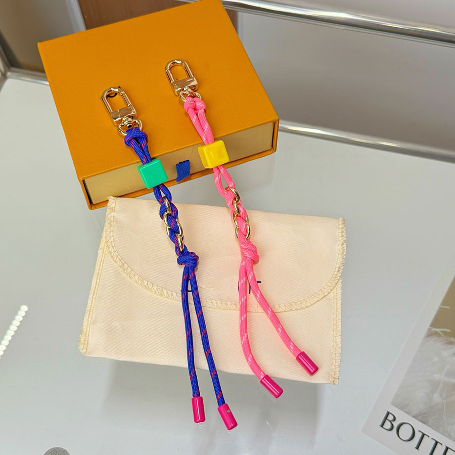 Designer Porte-clés Tendance Macaron Cordon tressé Sac Pendentif Corde nouée Porte-clés Dés Perle Clip Décoratif Charme Sac À Main Bagages Suspen