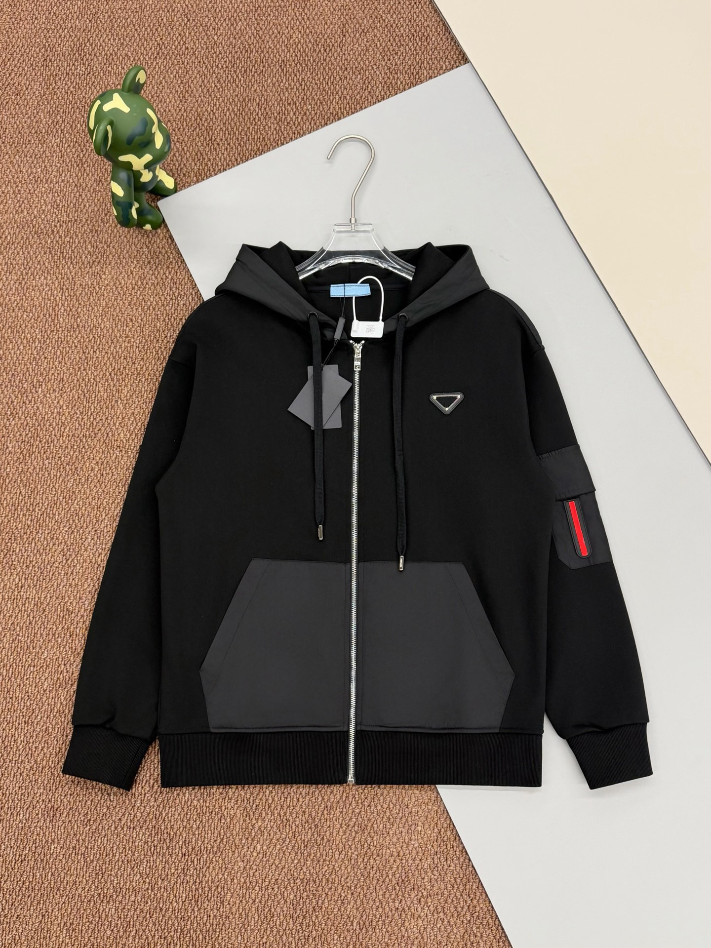 Designer's full zip hooded cardigan sweatshirt with classic triangular metal logo; Nylon patchwork kangaroo pocket with zipper side pockets on