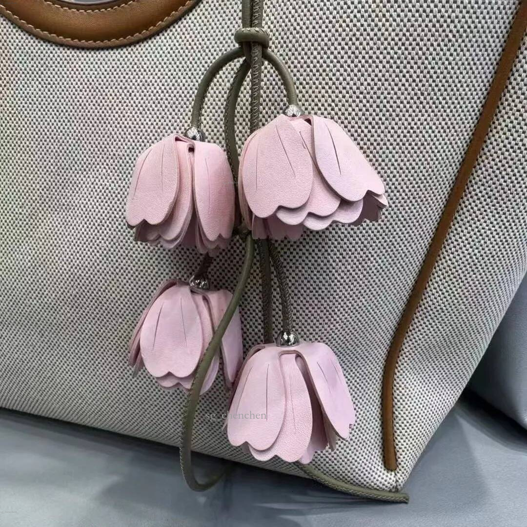 2026SS New Genuine Leather Pink Flower Bag Charm Handwoven Wind Chime Keychain Luxury Designer Pendant Fashion Car Keyring Decor