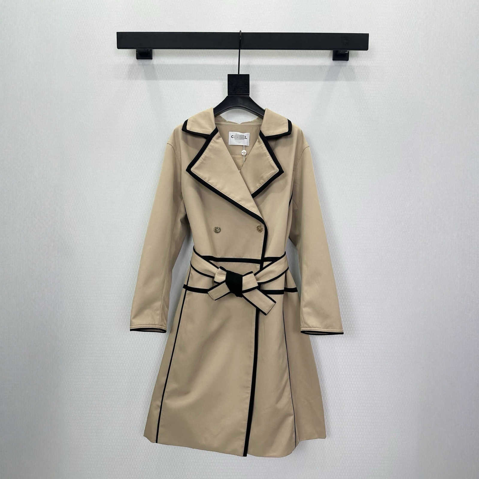 designer Women's Trench Coats Khaki mid-length trench coat for women, with black trim, embossed gold buckle belt, and a cinched waist for an el