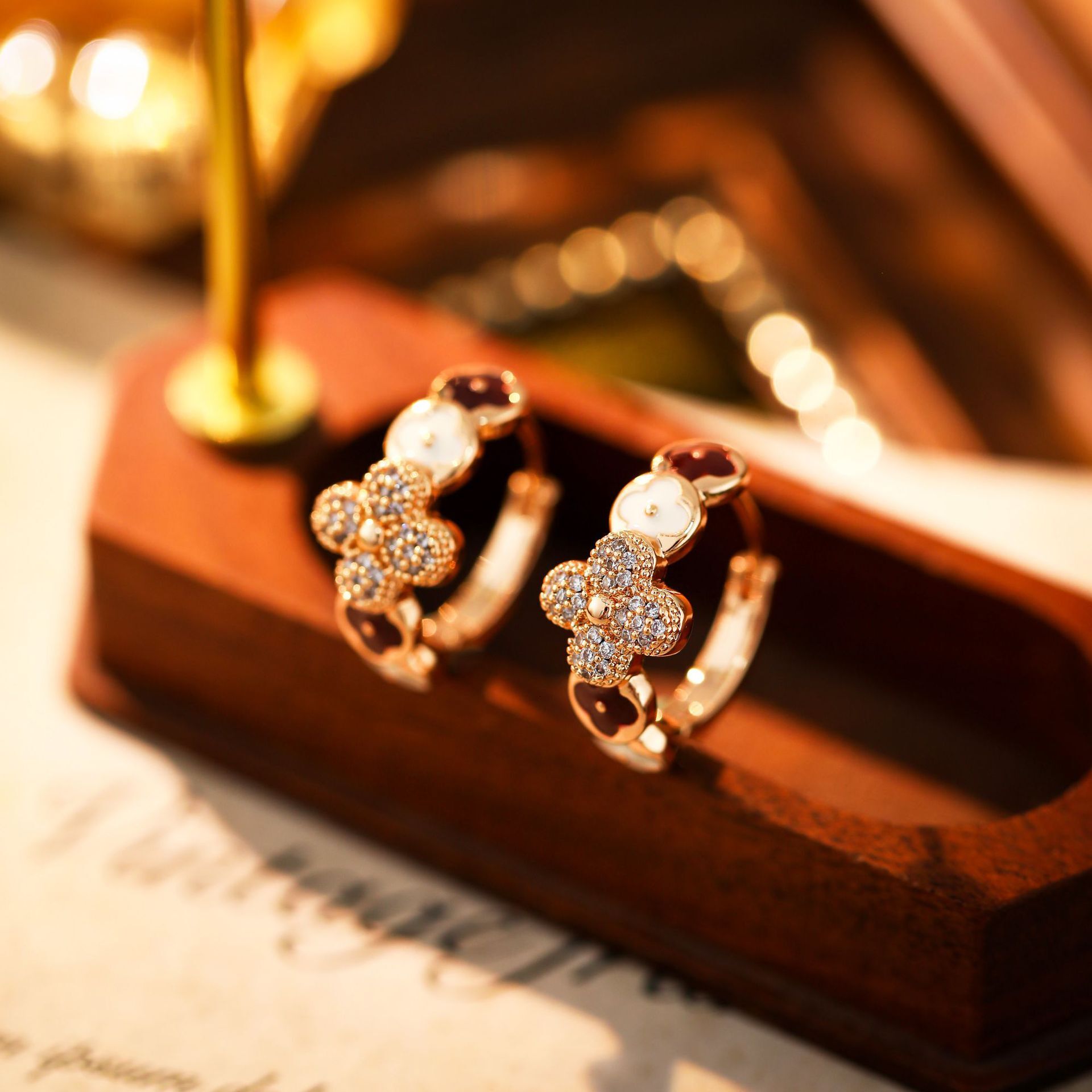 Korean-style minimalist cubic zirconia four-leaf clover earrings, featuring sophisticated luxurious design, unique understated aesthetic, a delicate