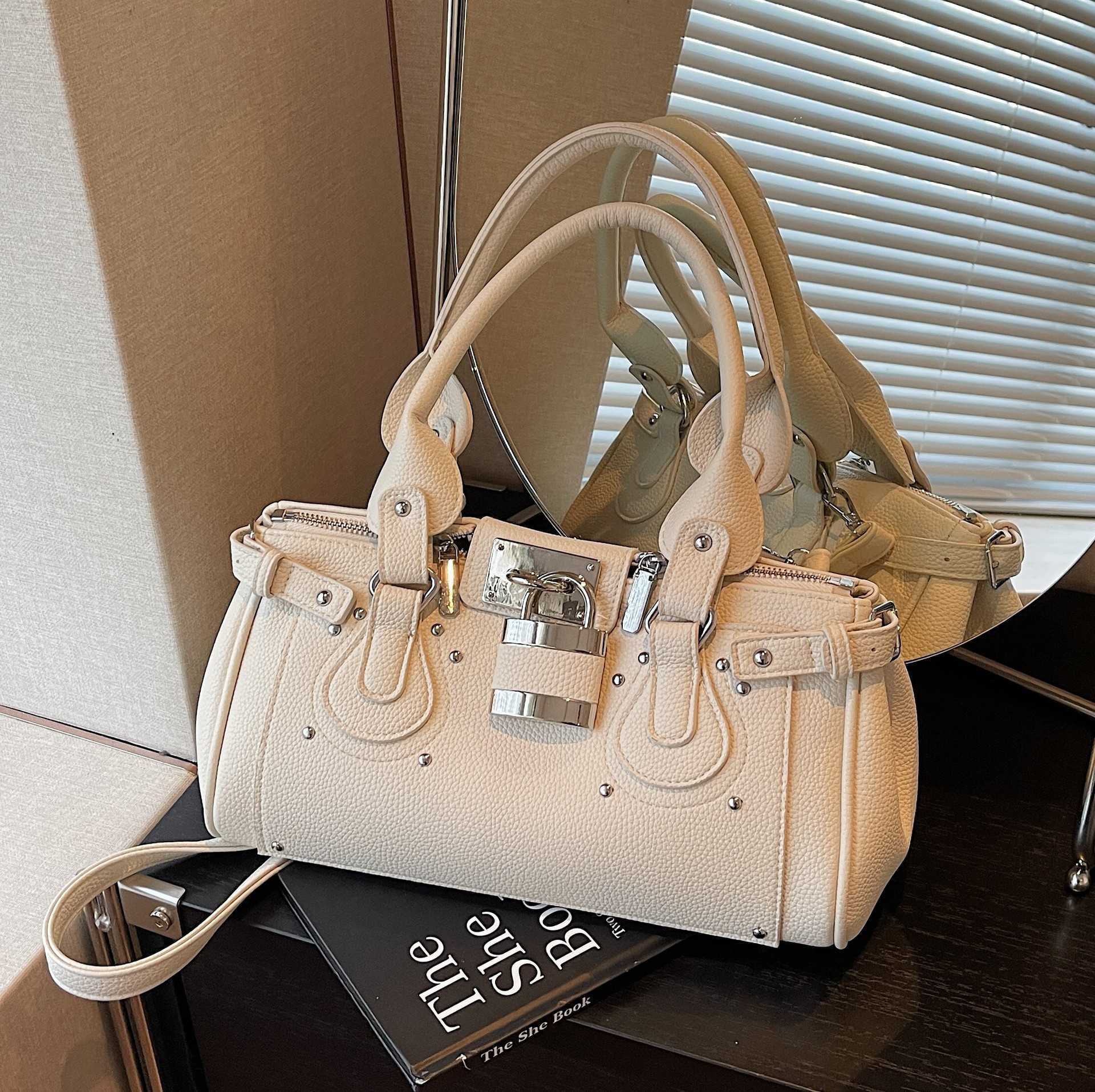 Large-capacity 2026 spring new trendy fashion biker bag hand-held shoulder underarm with rivet decoration pillow bag Q261016