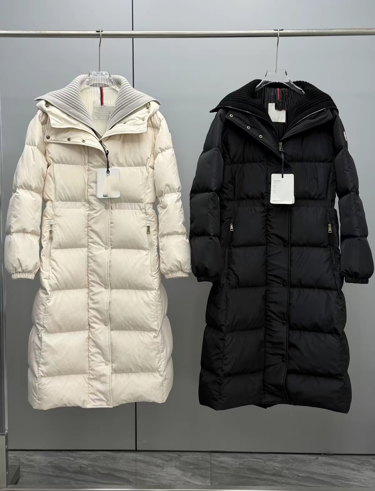 The designer's new long women's down jacket of the same series features a duplicate design of outdoor down jacket faux two-piece construct