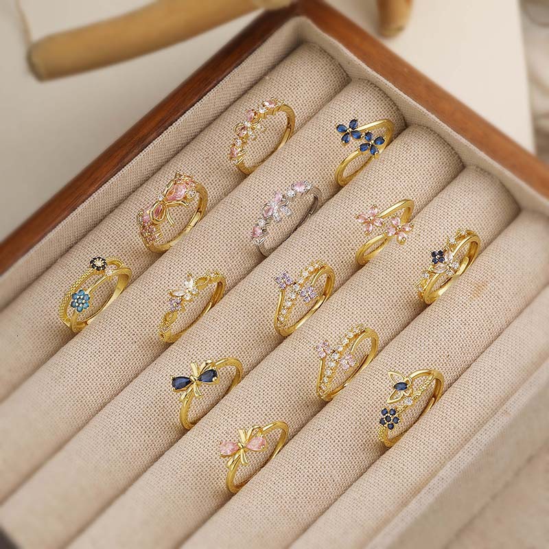 V brand ring Elegant copper ring with colorful diamond accents, featuring bow four-leaf clover design, a unique floral butterfly motif, and an adjus