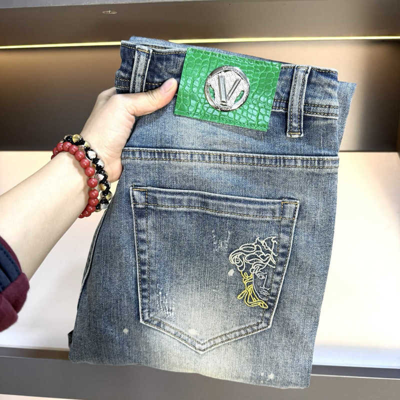 designer Men's Jeans High-end European-style men jeans with embroidered distressed details, slim stretchy, washed finish, and slightly straight