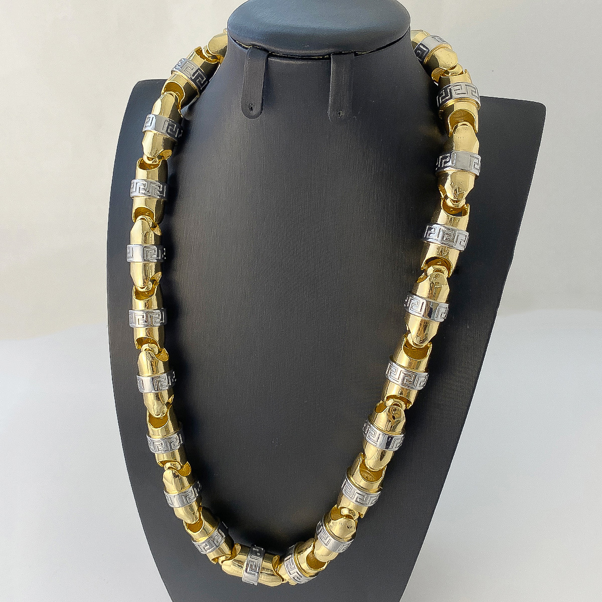 Retro, exaggerated, and luxurious two-tone cylindrical necklace with textured bead chain, a statement piece for street style