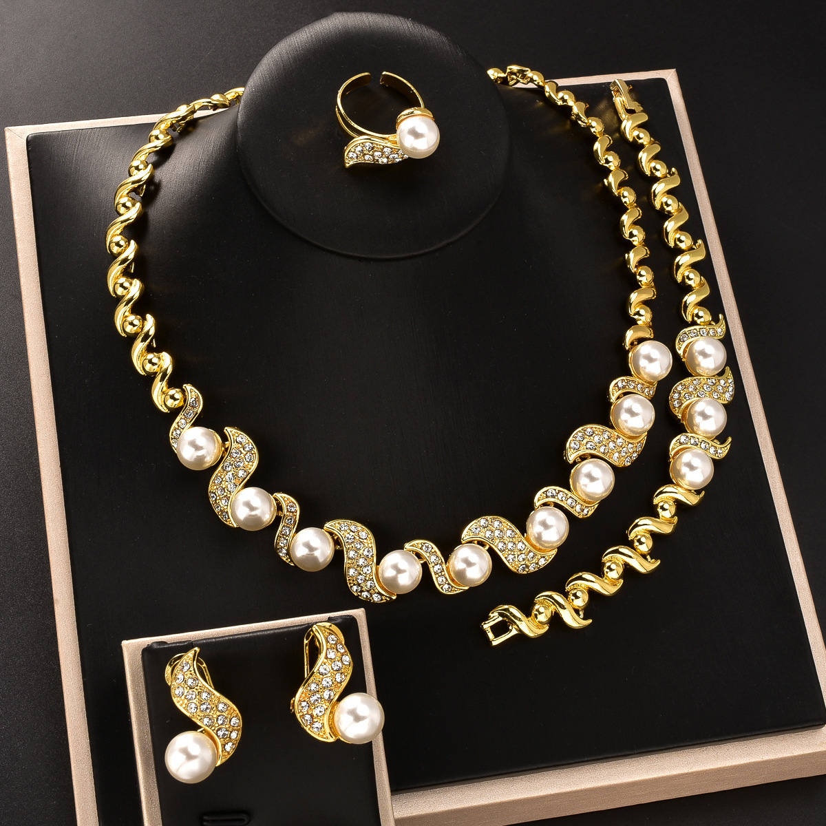 Dubai-style imitation pearl jewelry set with diamond-studded necklace, earrings, bracelet, and ring, a luxurious design for formal wear
