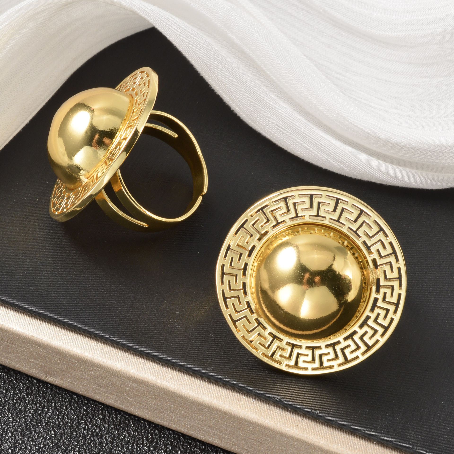European American retro-style open with large, half-sphere design, featuring exaggerated geometric relief patterns, adjustable, and suitable as a Mi