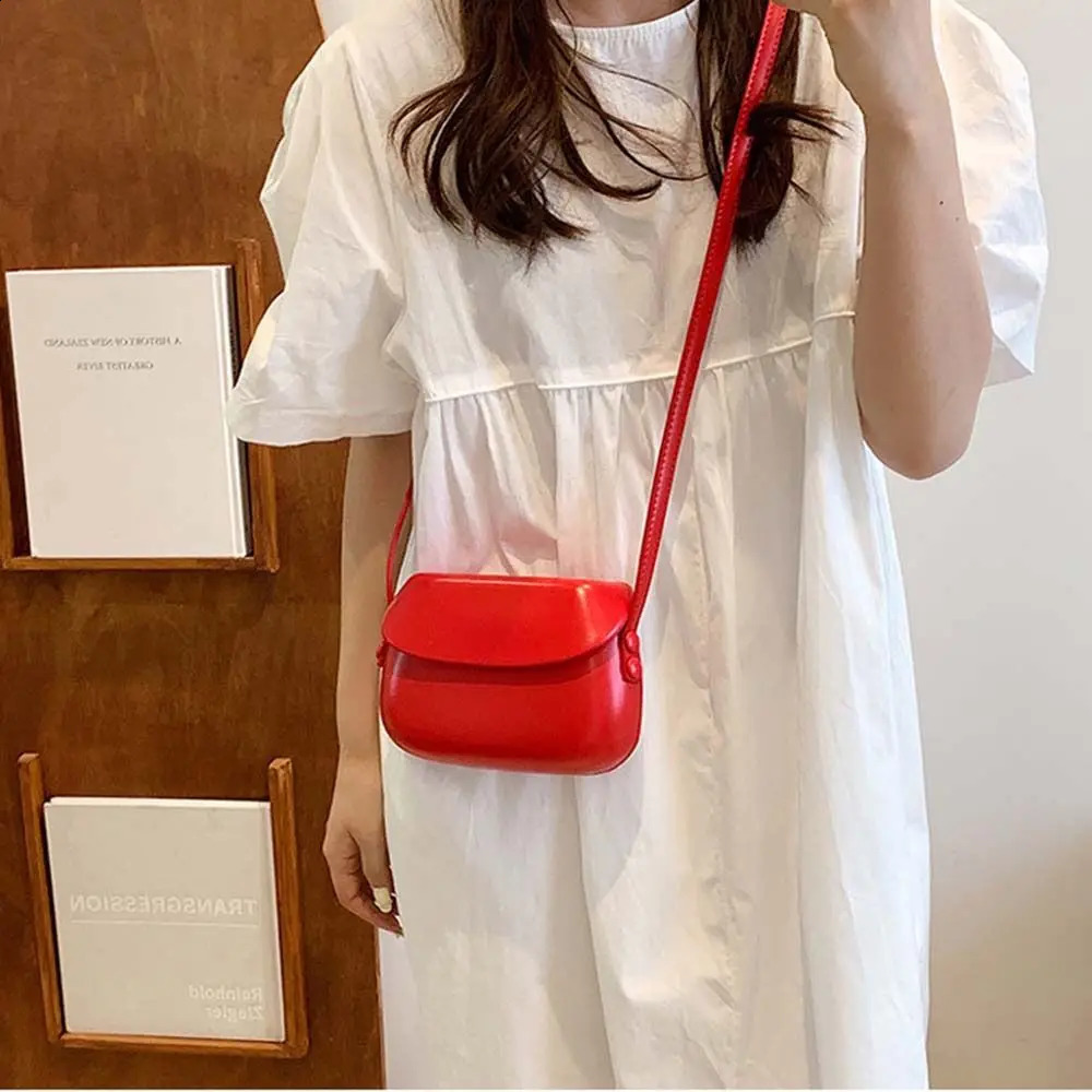 PU leather candy colored shell bag solid color fashion flip cross shaped bag shoulder bag Korean casual saddle bag 240912