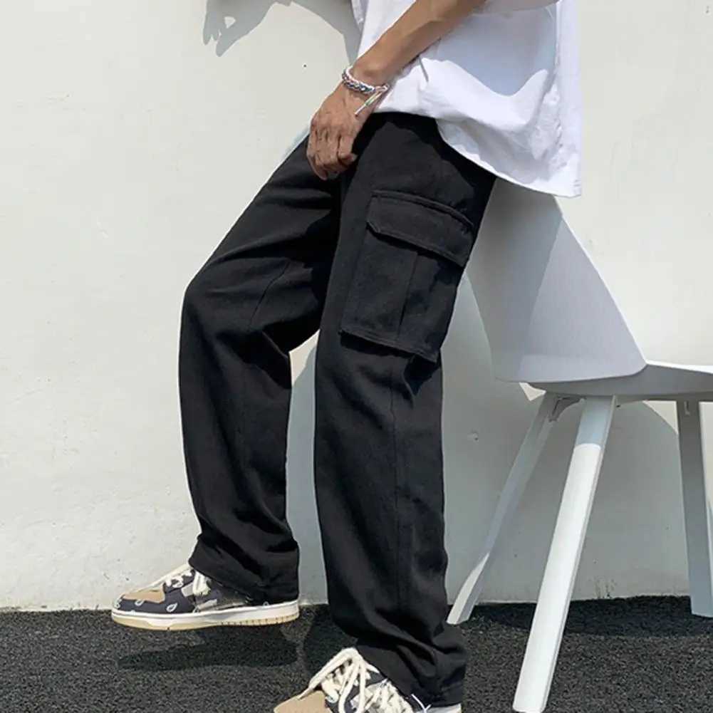 Pantalon de cargaison pour hommes Couleur massive de style hip-hop motif en vrac plusieurs poches de la taille élastique pantalon cargo w240923
