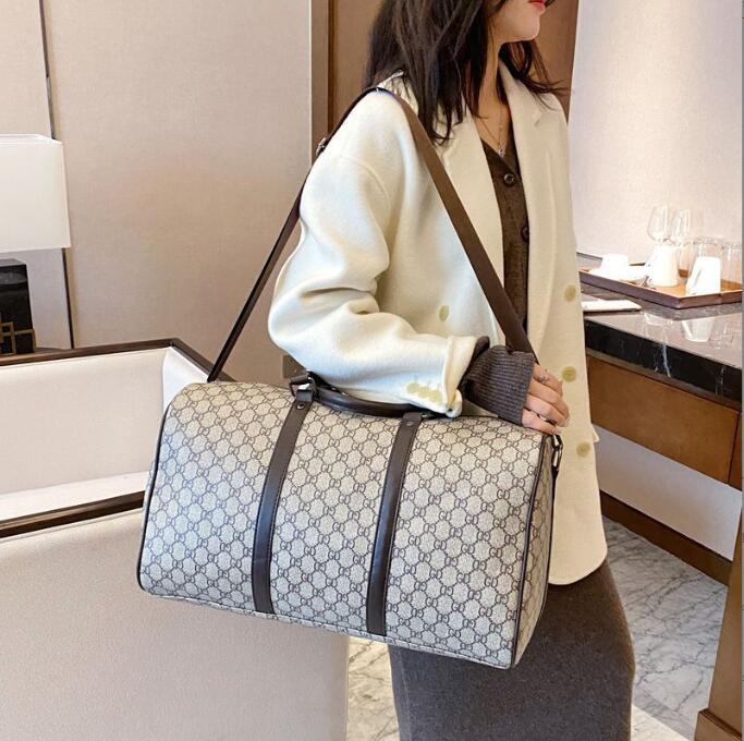 Packs Duffel Bags men women high-quality travel duffle bags brand designer luggage handbags With lock large capacity sport bag size 55CM-image-977283678