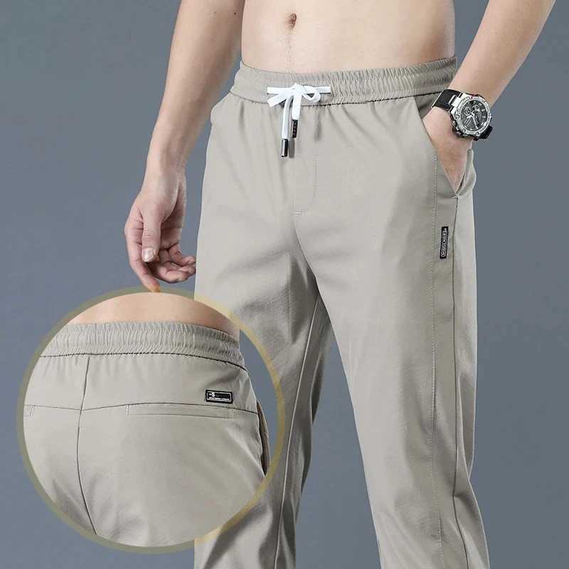 Mens Nouveau pantalon décontracté avec stretch à la mode slim slim hong kong de style glace en soie ample toutes tendances pantalon de jogging ét