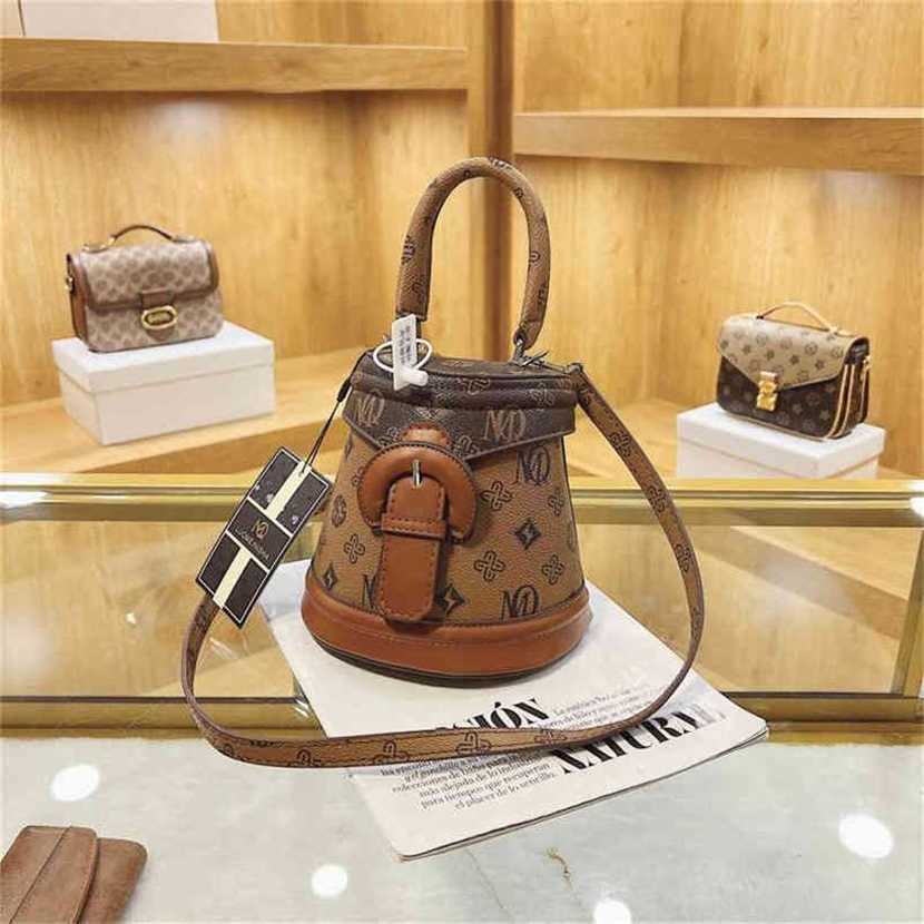 

handbag 2023 Fashion women's bag leather quality Handbag Niche Flip Bucket female spring flower handbag texture Shoulder Messenger Bag, Brown4
