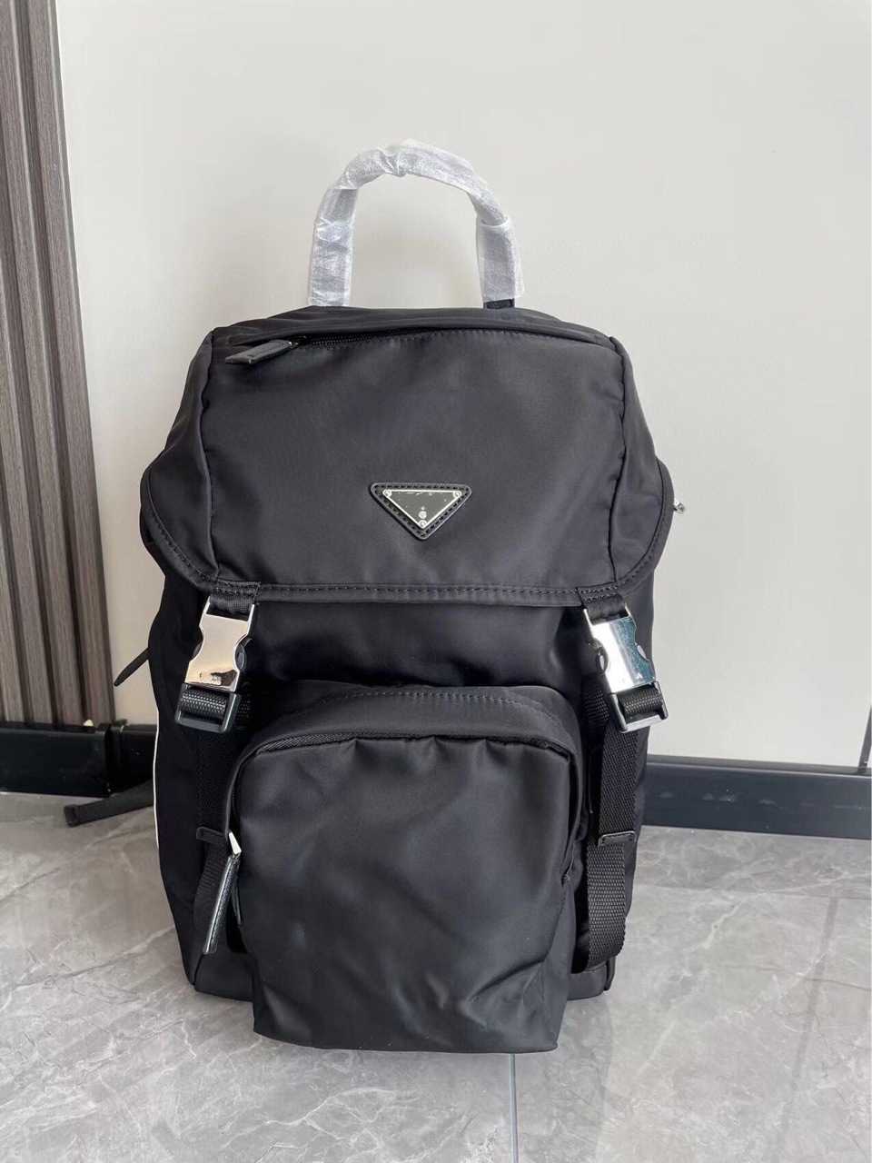 

Prads crossbody purses designer bags Prade P's three-cornered co-branded men's backpack leisure travel bag, Silver