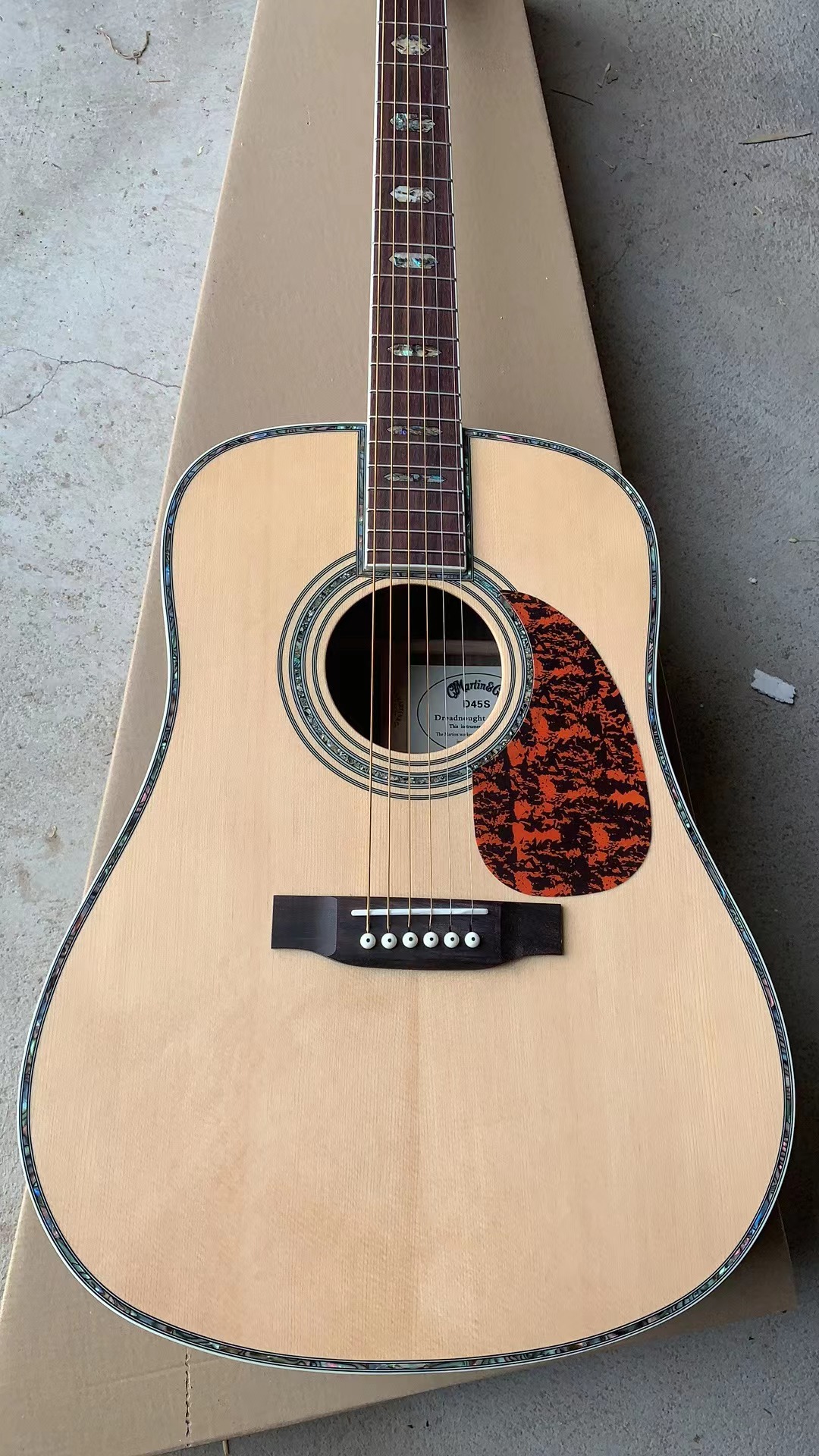 

coustic guitar. Spruce veneer and rosewood back and sides abalone shell inlay, with hard case