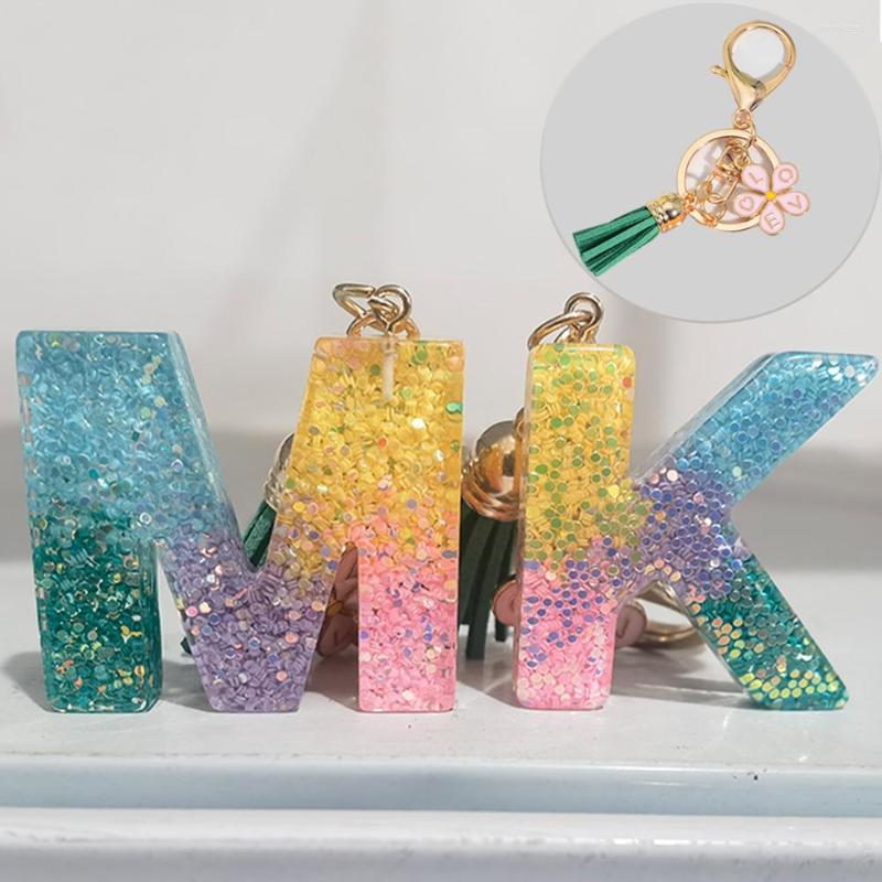 

Keychains 26 Letters Keychain With Pink Flower Green Tassel Pendent Rainbon Sequins Filled Acrylic Keyring Alphabet Key Chains Bag Decor