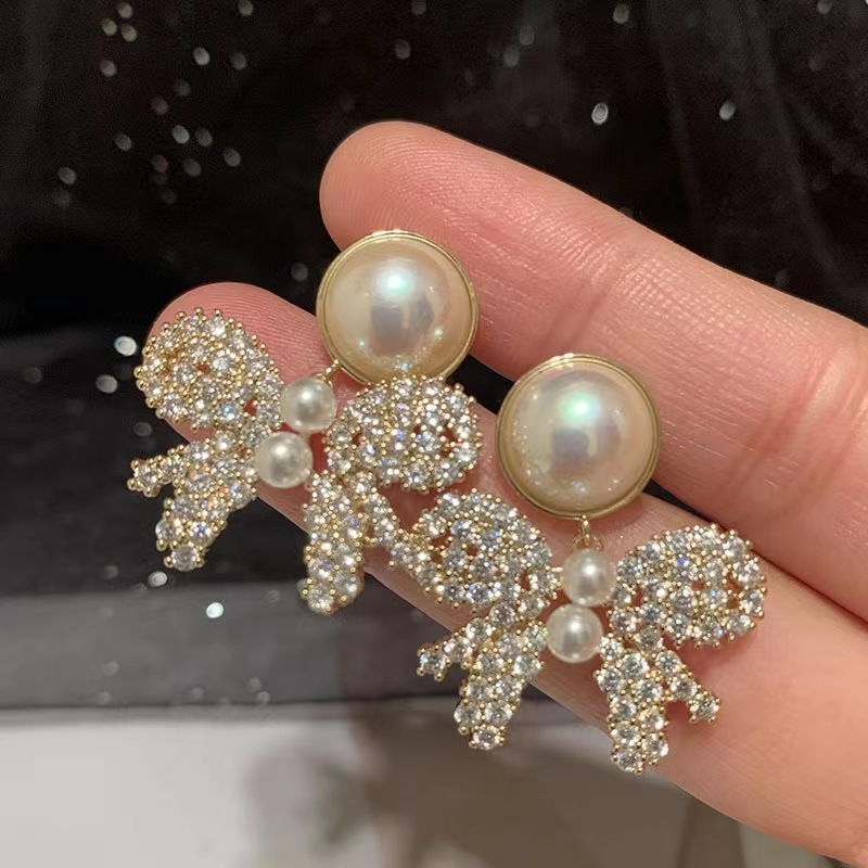 

S925 silver needle Japanese and Korean style hollowed-out flash diamond bow earrings personalized fashion hollow-out design sense earrings pearl style