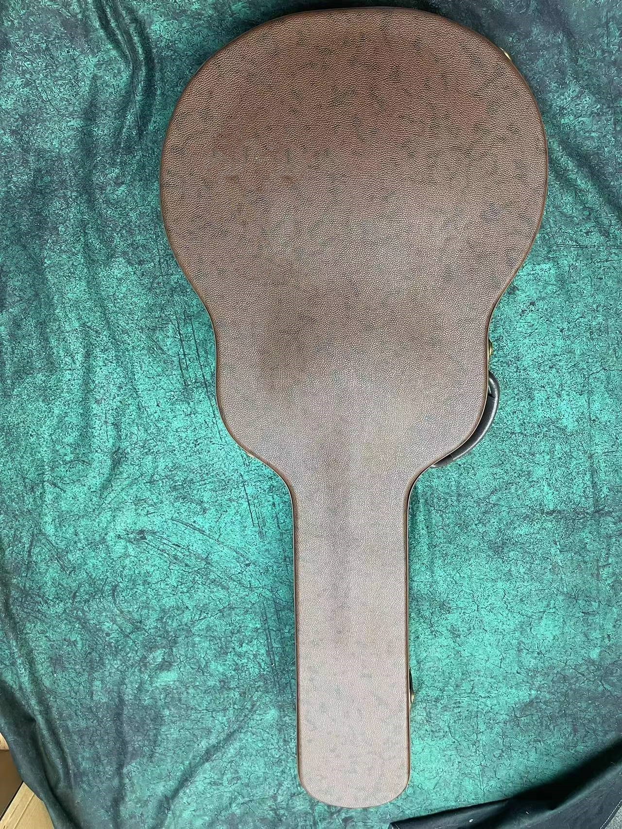 

Guitar suitcase and hard case. It can hold 34-43 inches. Brown outside red inside wool.