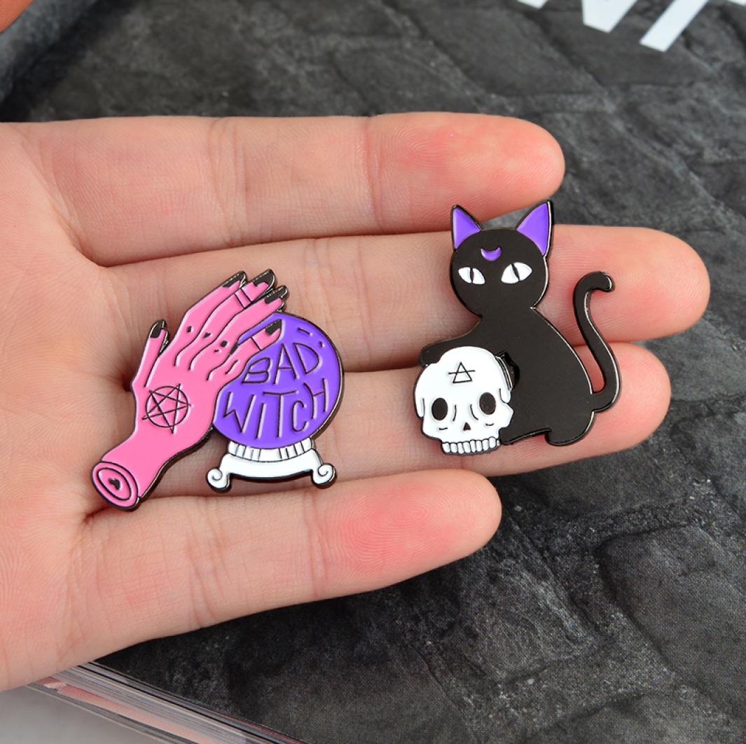 

Purple Magic Ball quotBAD WITCHquot Pink Hand Cat Holding Skull Brooch Personality Creative Decoration Special Cartoon Lapel J1047909
