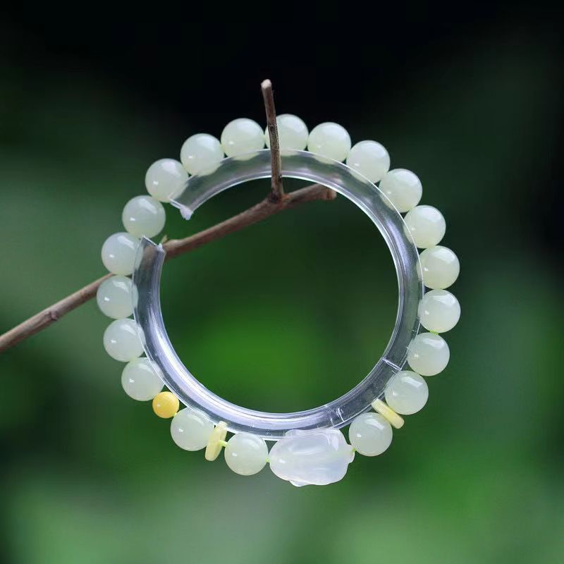 

Natural Hotan Jade Bracelet with Qingshui Rabbit Honey Wax Spacer Accessories Design Elegant Style for Boys and Girls
