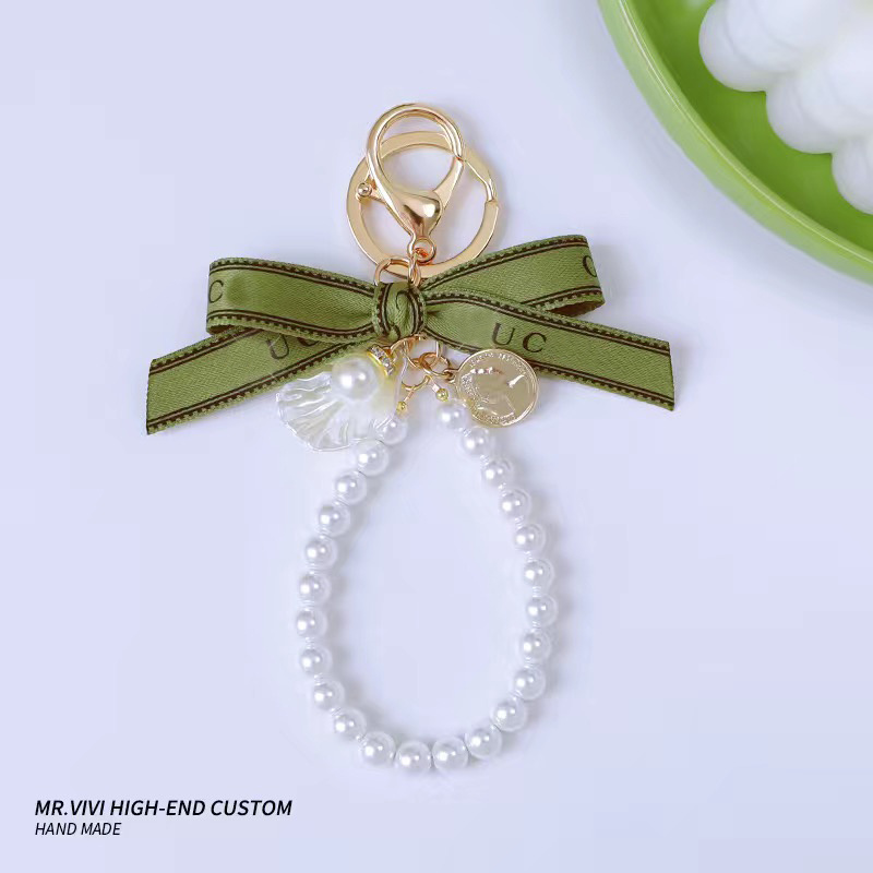 

Fashion Car Keychains Pendant Casual Antique Bell Orchid Green Ribbon Pearl Designers Key Chain With Letter Heart Bow Pendant Chain