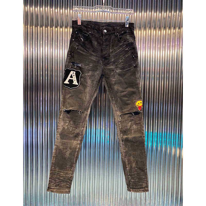 

new amirs washed worn tie dyed black letter bae knife cut hole slim legged jeans