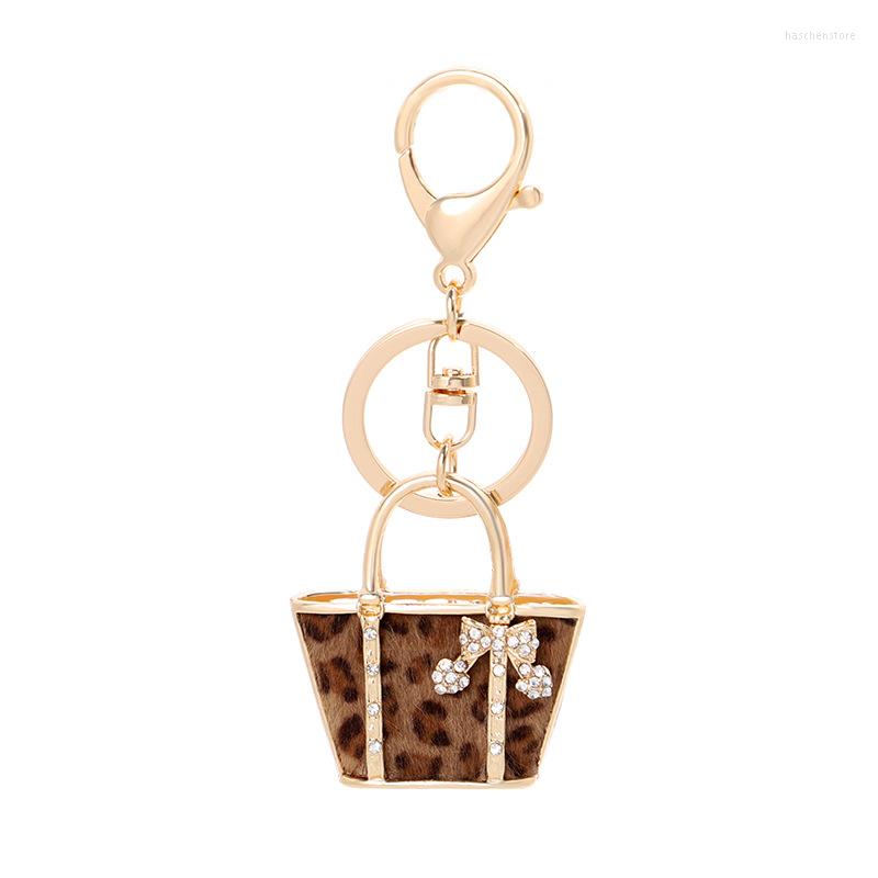 

Keychains 2022 Creative Leopard Handbag Shape Crystal Bow Keychain Exquisite Car Holder Bag Pendant Women Gift Trinket Metal Keyring
