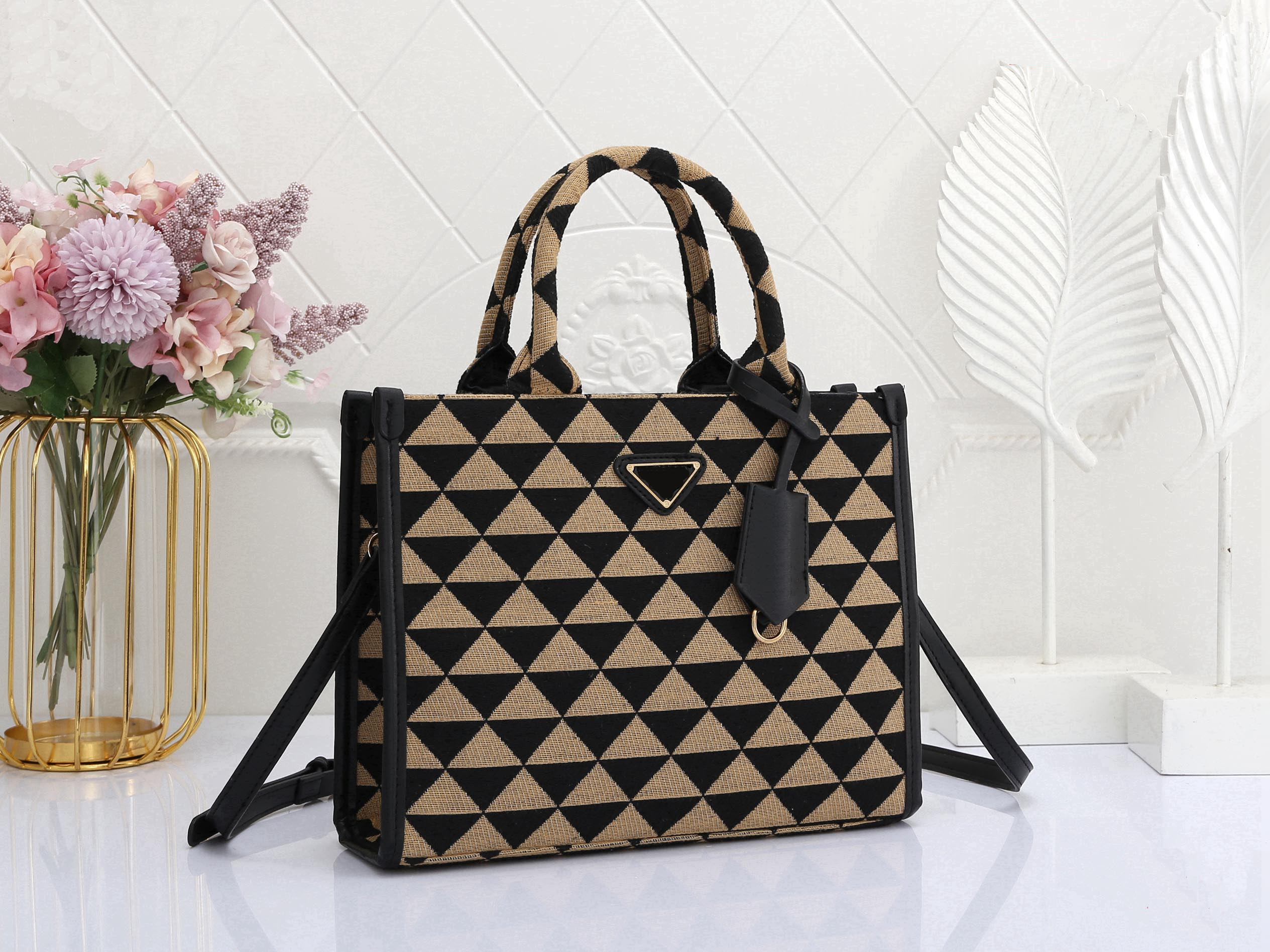 

Classic triangle-shaped Tote bag with a single shoulder strap strap and detachable leather key chain, Dust bag