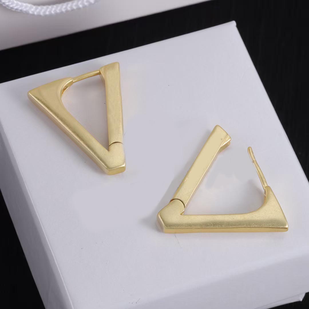 Luxury designer triangle earrings for women in 14K gold and brass. Stylish and simple. Perfect for gifting jewelry.