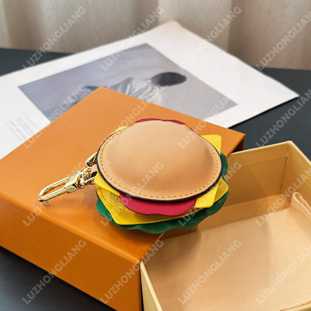 High-end designer keychain for 2025, stylishly pieced together, featuring a hamburger and headphone motifs as pendants and accessories.