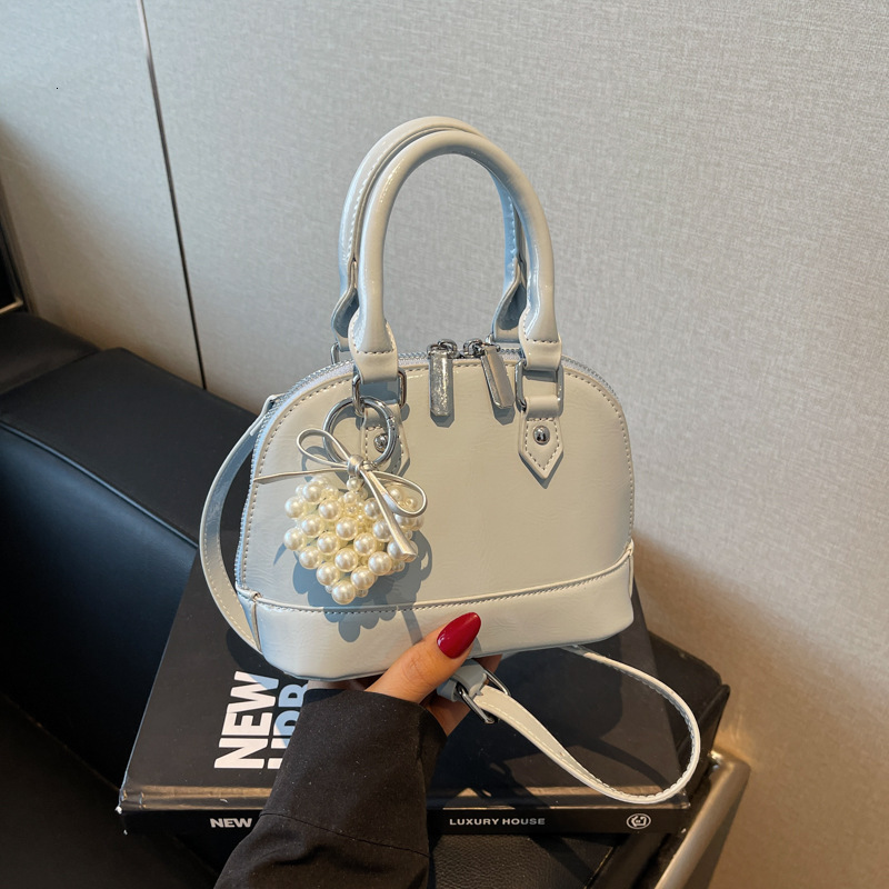 Niche Solid Color Multi Functional Handheld Luxury Designer 2025 Spring/summer New Women's Shell Bag Exquisite Fashion Single Shoulder Crossbod