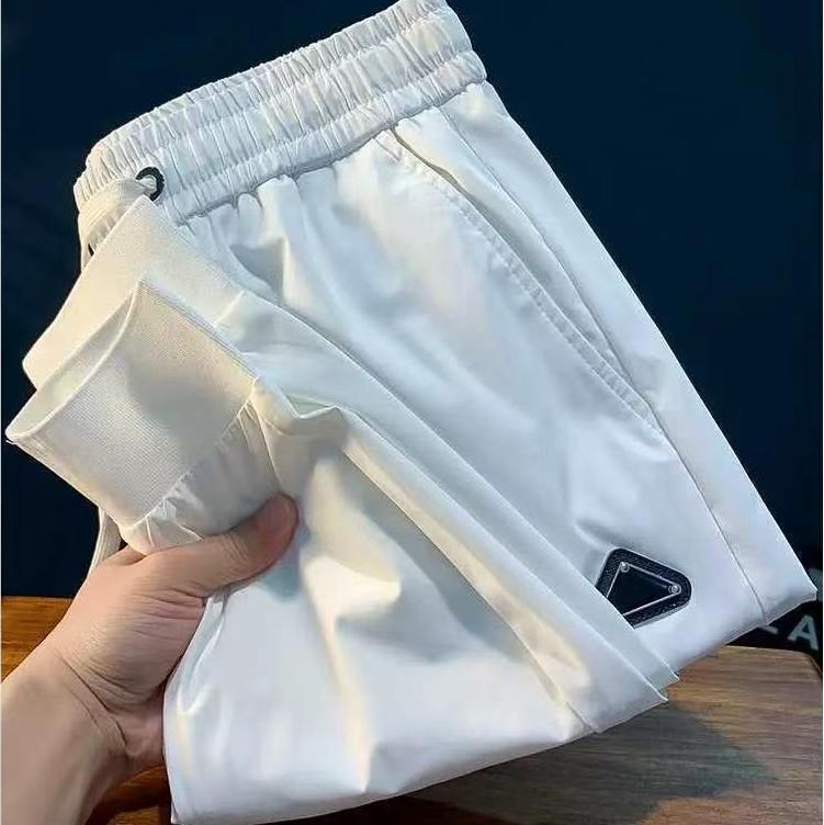 Designer style ice silk quick drying men's casual pants for autumn 2025, thin stretch elastic waist sports pants, slim fit and leg binding pant
