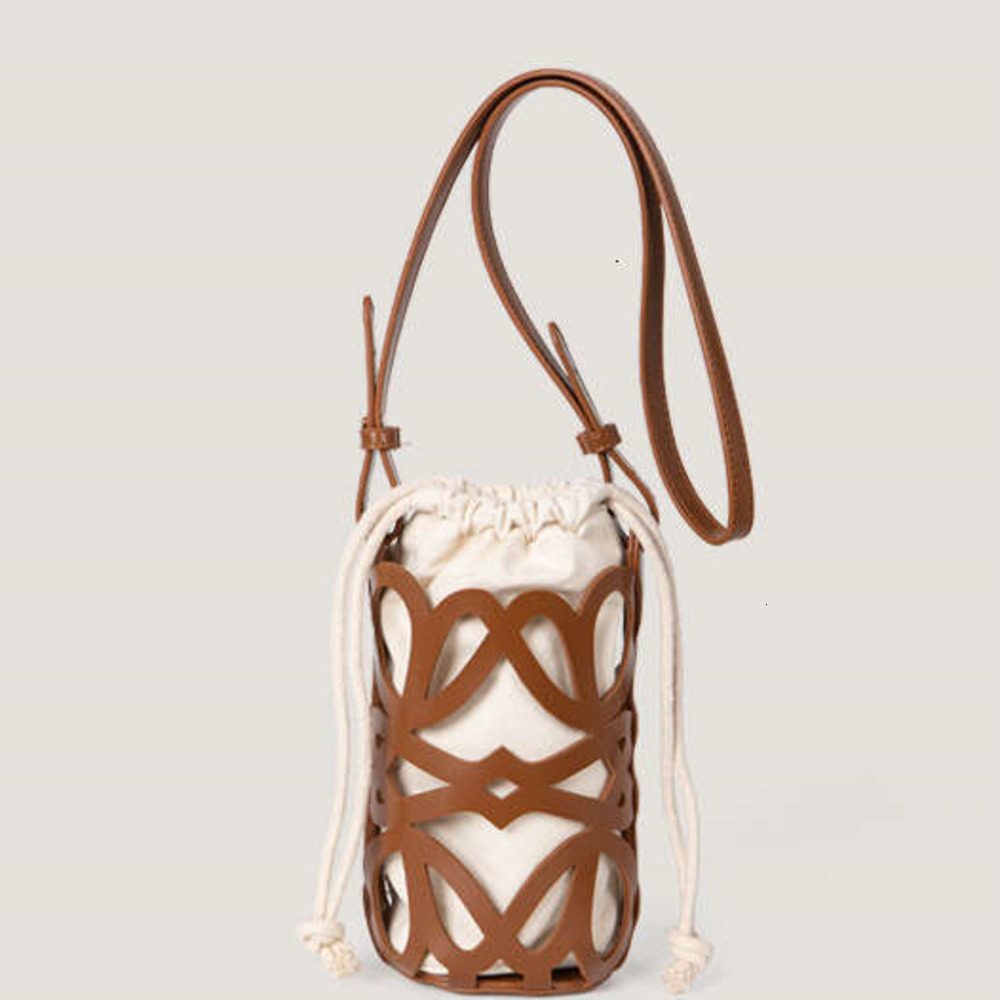 Sacs de soirée Nouveau design de niche coréen creux en toile à cordon cymand sac à bandoulière cylindrique.