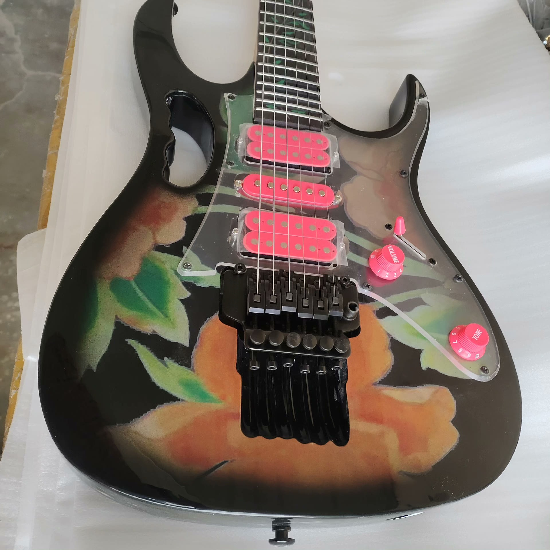 Striking Black Guitar with Vivid Floral Art: Orange/Green Hues, 3 Pink Pickups & Transparent Guard-image-1057788134
