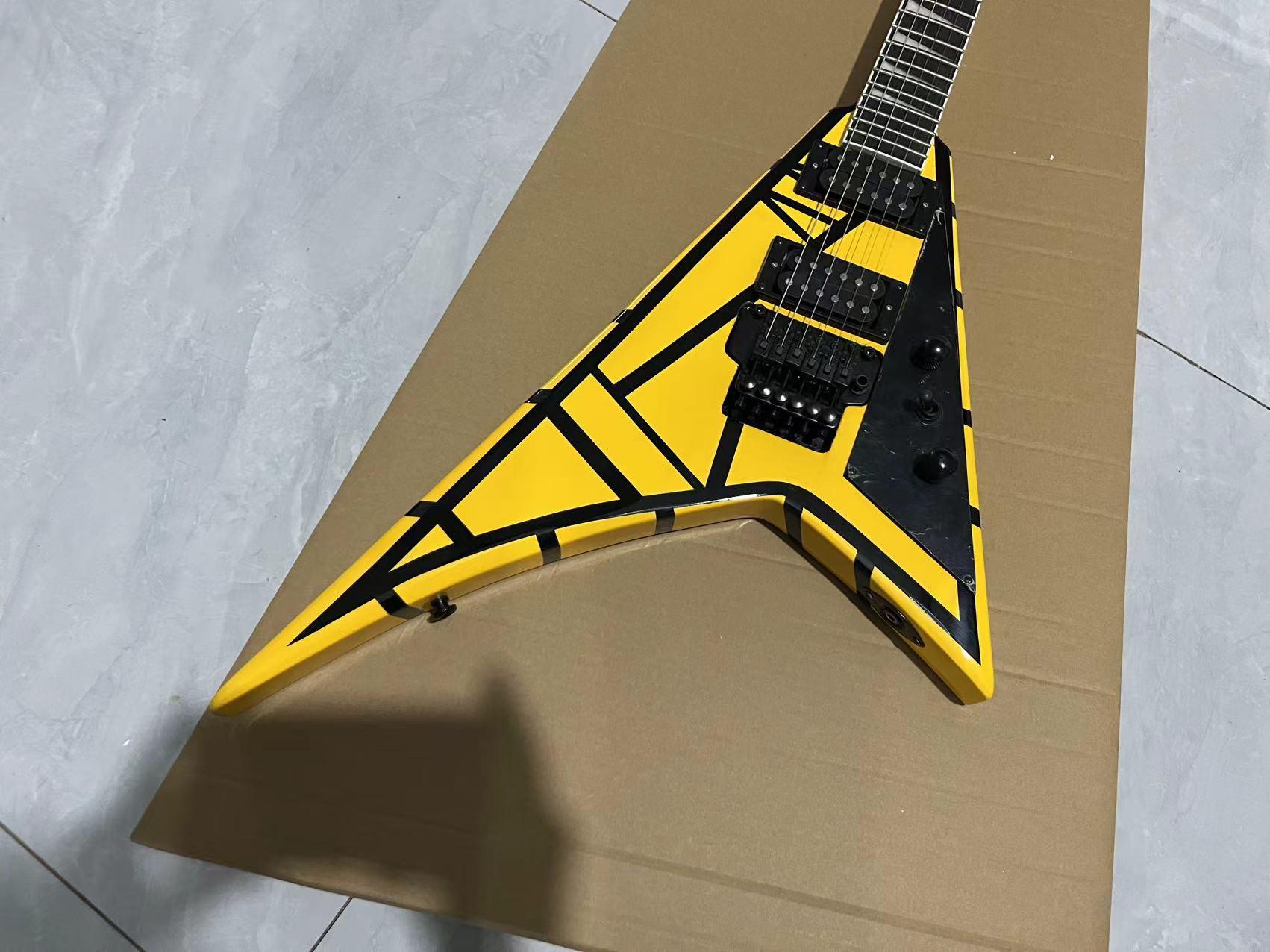 Bold Flying V-Style Guitar: Vibrant Yellow Finish with Black Geometric Patterns & Dual Humbuckers-image-1058629564