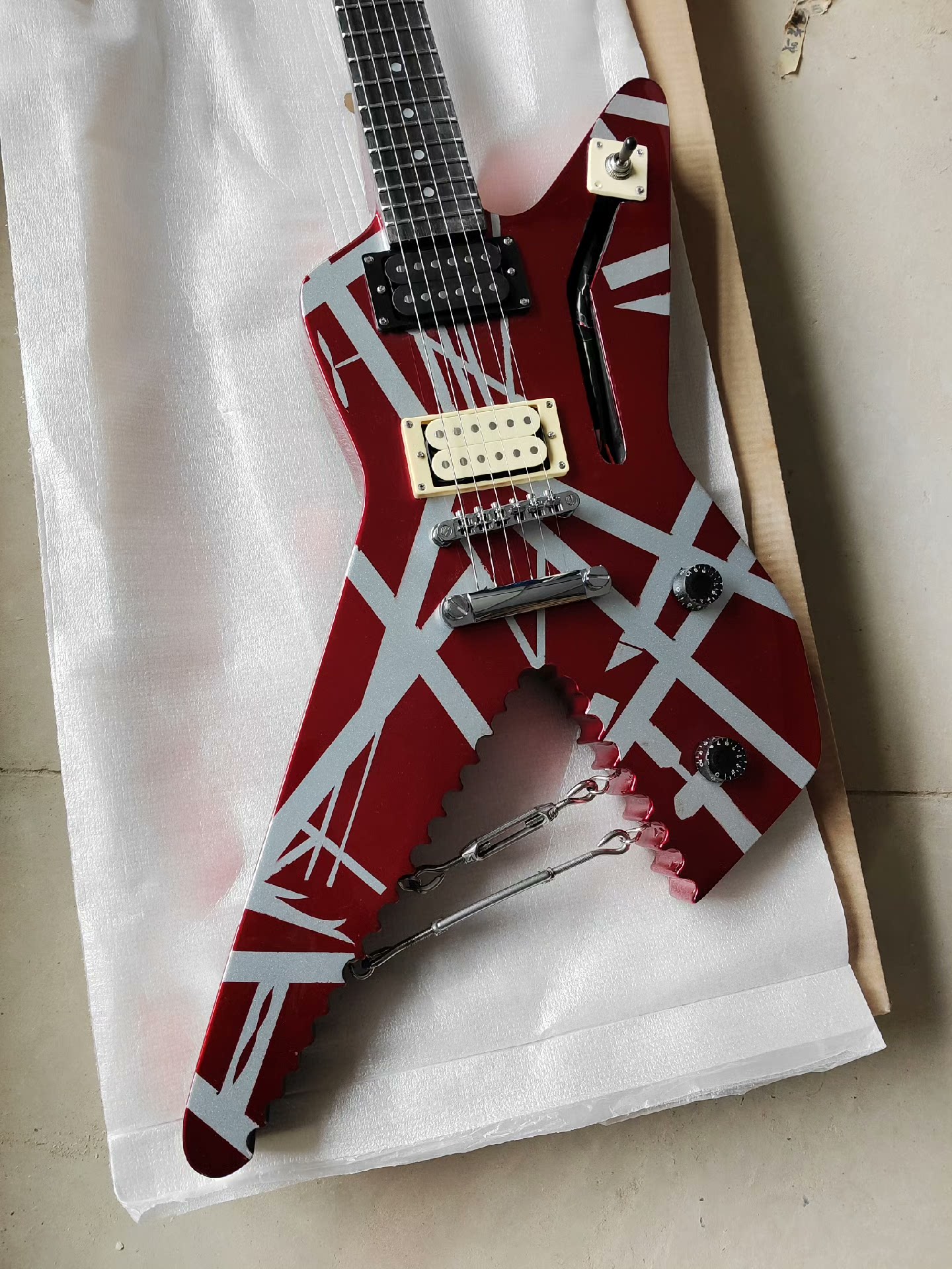 Bold Red Electric Guitar with White Geometric Patterns: Modified V-Shape, Dual Pickups, Tremolo Bridge-image-1058633352
