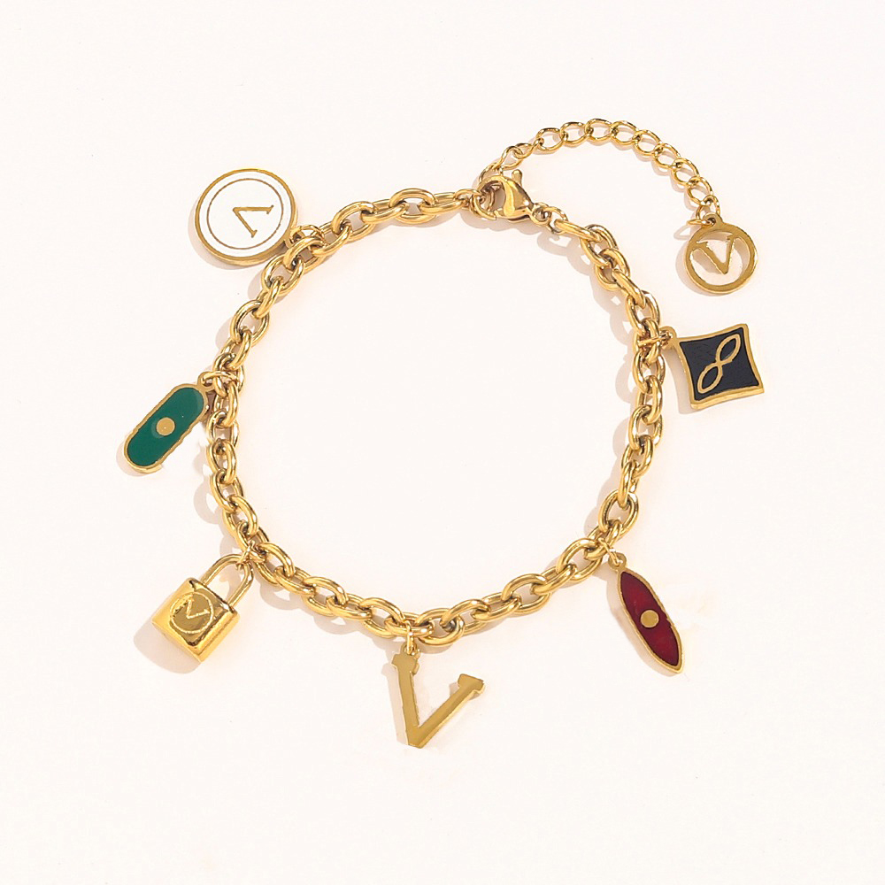 Bracelet en chaîne dorée avec pendentifs multicolores, y compris le charme de lettre et le motif de verrouillage des bijoux en couches élégantes